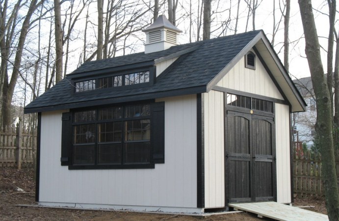 Cambridge-White shed with black shingle roof