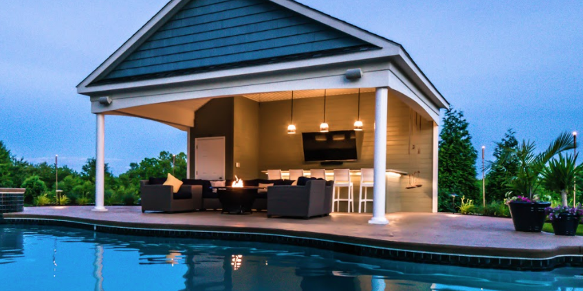 Outdoor Bar Structures for Backyard Entertainment Luxury outdoor bar structure with covered seating and backyard entertainment space.